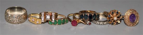 Nine assorted 9ct gold gem set rings and a silver band.